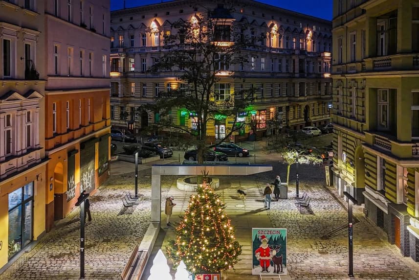 Świąteczna odsłona alei Wojska Polskiego Ozdobiona choinka stojąca na środku miejskiego placu